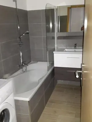 a bathroom with a bath tub and a sink at les orangers in Cannes