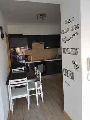 a kitchen with a table and chairs in a room at les orangers in Cannes
