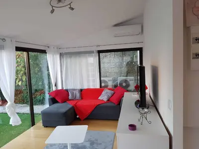 a living room with a couch with red pillows at les orangers in Cannes