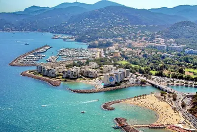 an aerial view of a beach and a harbor at les orangers in Cannes