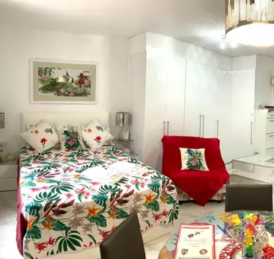 a bedroom with a bed with pillows and a picture on the wall at Cannes Apartment close to Congress Palace, Croisette, Beaches in Cannes