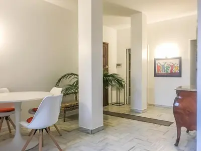 a living room with a white table and chairs at Cannes - Beachfront with private garden - Palm Beach Croisette in Cannes