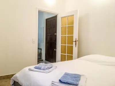 a bedroom with a bed with two towels on it at Cannes - Beachfront with private garden - Palm Beach Croisette in Cannes