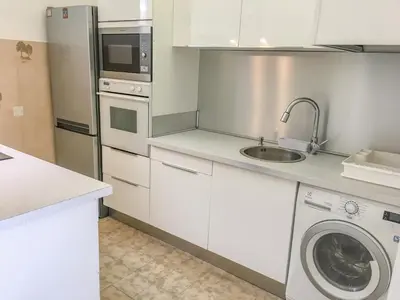 a kitchen with a sink and a washing machine at Cannes - Beachfront with private garden - Palm Beach Croisette in Cannes
