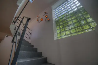 a staircase with a large window in a building at IMMOGROOM - Beautiful duplex - Sea view - Quiet - AC - Wifi - Garage in Cannes