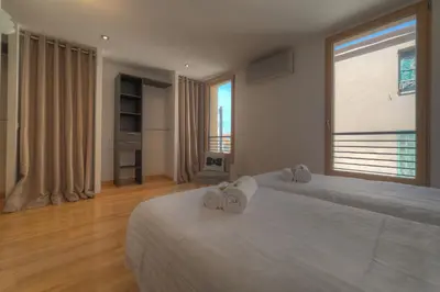 a bedroom with two beds and a large window at IMMOGROOM - Beautiful duplex - Sea view - Quiet - AC - Wifi - Garage in Cannes