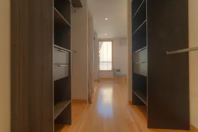 a walk in closet with black cabinets and a chair at IMMOGROOM - Beautiful duplex - Sea view - Quiet - AC - Wifi - Garage in Cannes
