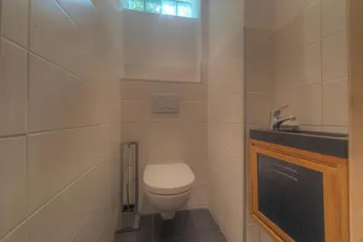 a small bathroom with a toilet and a sink at IMMOGROOM - Beautiful duplex - Sea view - Quiet - AC - Wifi - Garage in Cannes