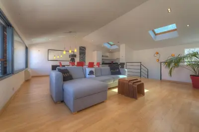 a living room with a blue couch and a table at IMMOGROOM - Beautiful duplex - Sea view - Quiet - AC - Wifi - Garage in Cannes