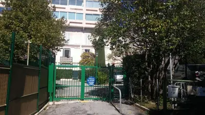 a green gate in front of a building at Residence Saint Marc in Cannes