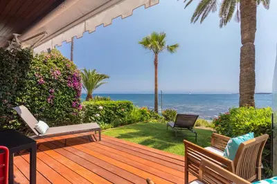 a wooden deck with a view of the ocean at Résidence Vue Mer Cannes in Cannes