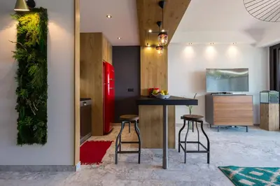 a living room with a flat screen tv on a wall at Résidence Vue Mer Cannes in Cannes