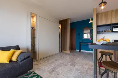 a kitchen with a red refrigerator and two bar stools at Résidence Vue Mer Cannes in Cannes