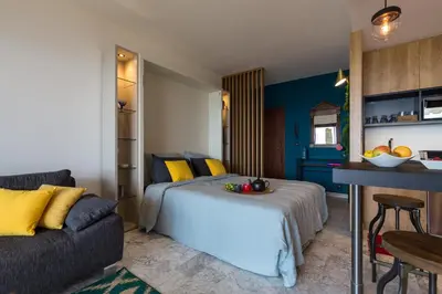 a living room with a couch and a table at Résidence Vue Mer Cannes in Cannes