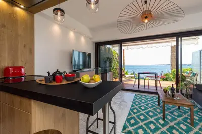 a kitchen with a counter with a bowl of fruit on it at Résidence Vue Mer Cannes in Cannes