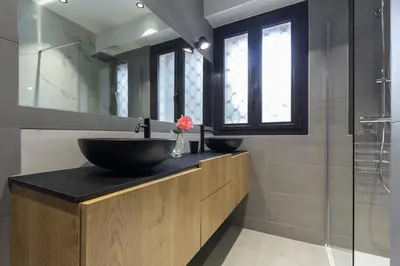 a bathroom with two sinks and a glass shower at Résidence Vue Mer Cannes in Cannes