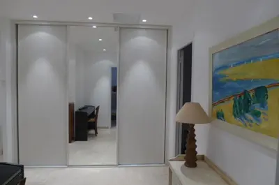 a room with a hallway with a painting and a lamp at Alouette in Cannes