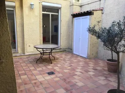 a picnic table on a brick patio with a garage at Alouette in Cannes
