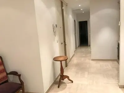 a hallway with a stool next to a wall at Alouette in Cannes