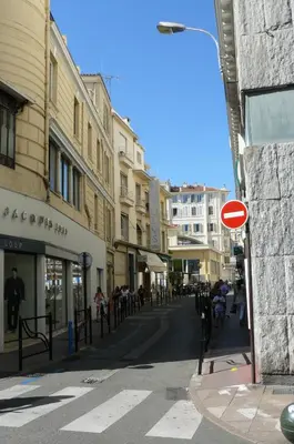a street in a city with a red sign at Appartement Palais des Festivals in Cannes