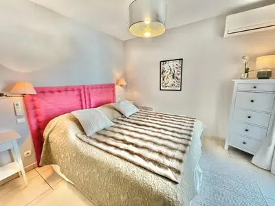 a bedroom with a bed with a pink head board at Bristol by Welcome to Cannes in Cannes