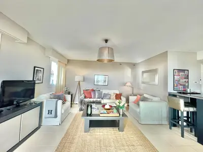 a living room with a couch and a table at Bristol by Welcome to Cannes in Cannes