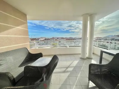 a balcony with chairs and a table and a large window at Bristol by Welcome to Cannes in Cannes