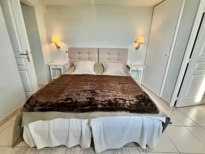 a bedroom with a large bed with two tables at Bristol by Welcome to Cannes in Cannes