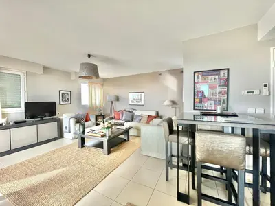 a living room with a couch and a table at Bristol by Welcome to Cannes in Cannes