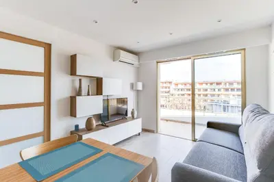 a living room with a couch and a table at IMMOGROOM - Renovated apartment - Terrace - AC - Wifi in Cannes
