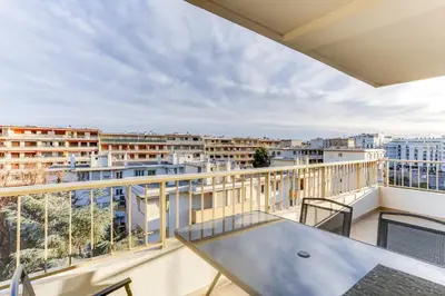 a balcony with a table and views of the city at IMMOGROOM - Renovated apartment - Terrace - AC - Wifi in Cannes