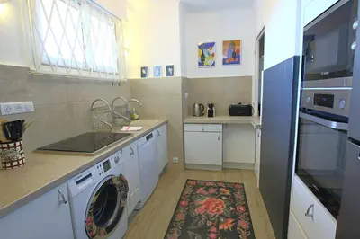a kitchen with a washing machine and a sink at Fully equipped appartment 105 m2 clear view on the sea and californie hills in Cannes