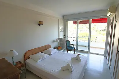 a bedroom with a bed with two towels on it at Fully equipped appartment 105 m2 clear view on the sea and californie hills in Cannes