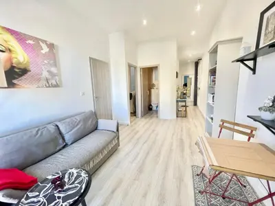 a living room with a couch and a table at Casa Valfa à 200m du Palais, by Welcome to Cannes in Cannes
