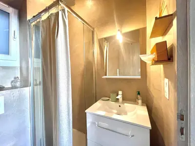 a bathroom with a shower and a white sink at Casa Valfa à 200m du Palais, by Welcome to Cannes in Cannes