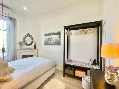 a bedroom with a bed and a mirror at Casa Valfa à 200m du Palais, by Welcome to Cannes in Cannes