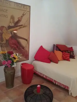 a room with two beds and a table with a candle at Studio à 2 pas du Palais in Cannes
