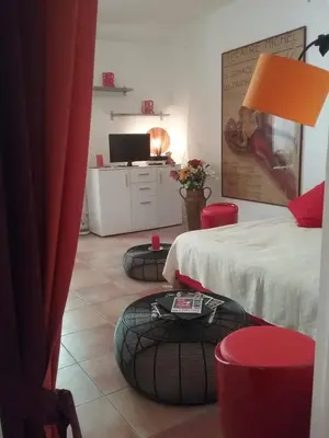 a bedroom with two beds and two ottomans at Studio à 2 pas du Palais in Cannes