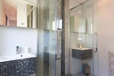 a bathroom with a glass shower and a sink at Cannes Vieux Port in Cannes