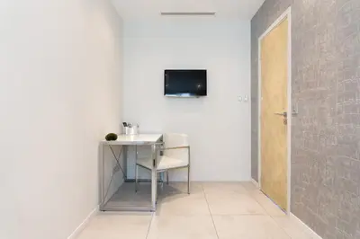 a room with a table and a television on a wall at Cannes Vieux Port in Cannes