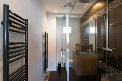 a bathroom with a glass shower and a sink at Cannes Vieux Port in Cannes