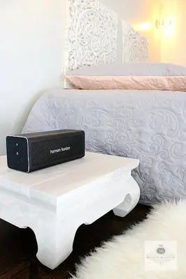 a laptop sitting on a table next to a bed at 'Maison Blanche' in Cannes