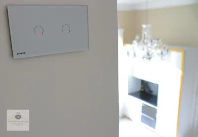a lightswitch on a wall with a chandelier at 'Maison Blanche' in Cannes