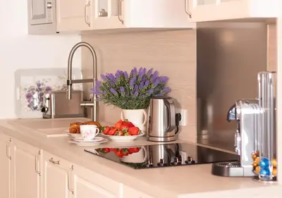 a kitchen counter with a tray of fruit and flowers at Cannes Imperial Croisette Palais Miramar in Cannes