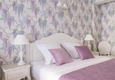 a bedroom with a bed with purple floral wallpaper at Cannes Imperial Croisette Palais Miramar in Cannes