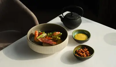 a bowl of food on a table with bowls of food at Five Seas by Inwood Hotels in Cannes