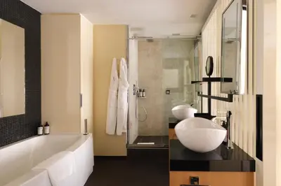 a bathroom with a tub and a sink and a shower at Five Seas by Inwood Hotels in Cannes