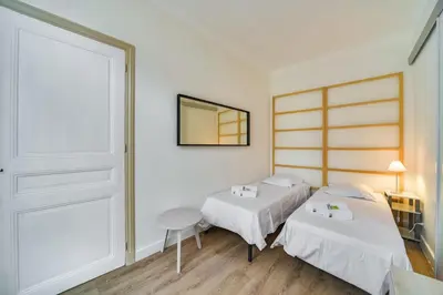 a bedroom with two beds and a mirror at IMMOGROOM- Close to the Palais des festivals- Wifi in Cannes