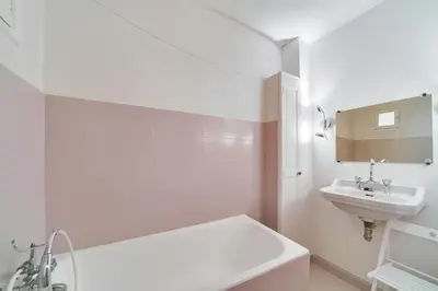 a white bathroom with a sink and a bath tub at IMMOGROOM- Close to the Palais des festivals- Wifi in Cannes