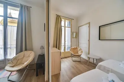 a bedroom with a bed and a tv on a wall at IMMOGROOM- Close to the Palais des festivals- Wifi in Cannes